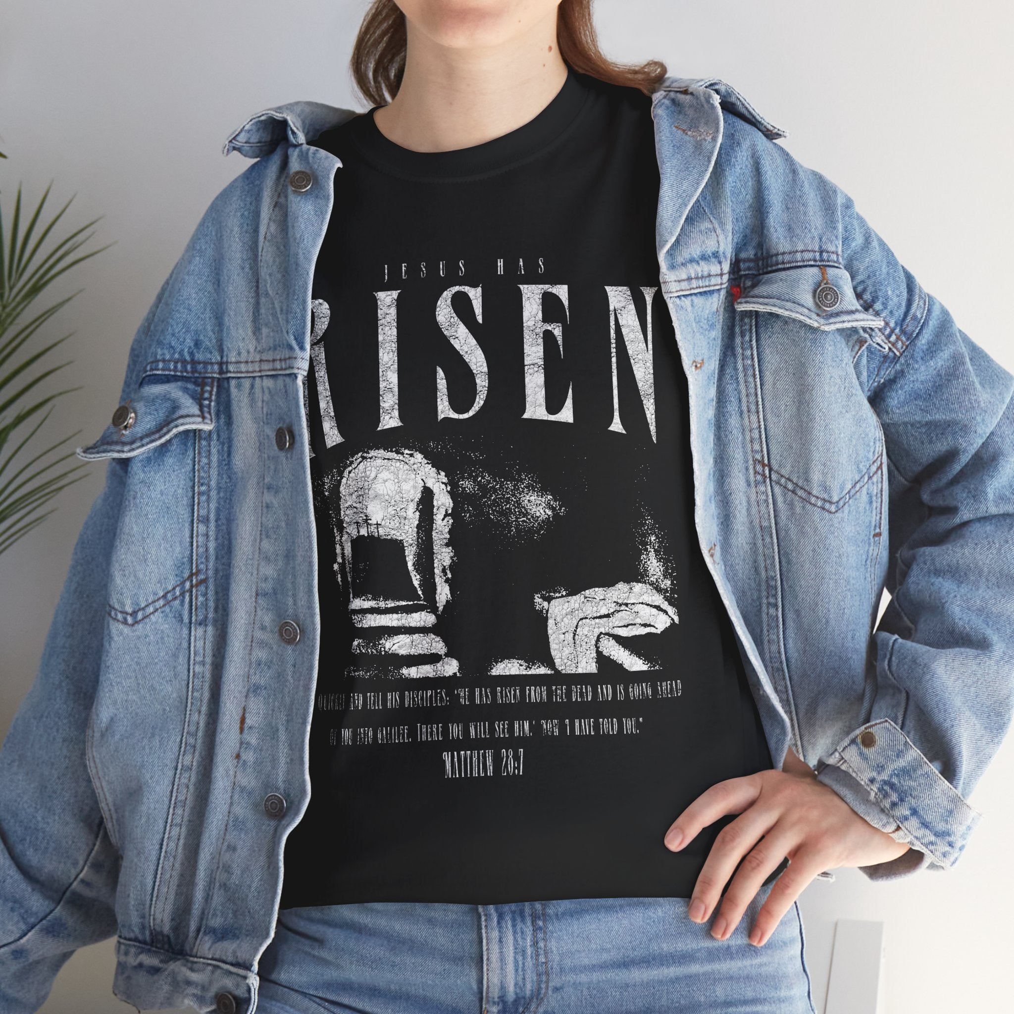 Christian resurrection shirt on model with bold “Jesus Has Risen” text and empty tomb artwork